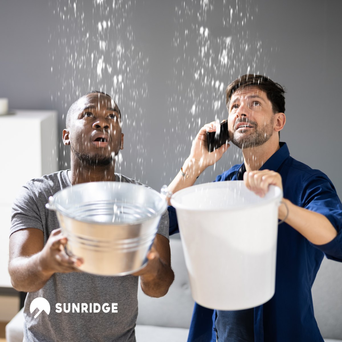 Two men catching water from a leaking ceiling with buckets, highlighting the importance of reliable plumbing solutions like Sunridge Rifeng multi-layer piping