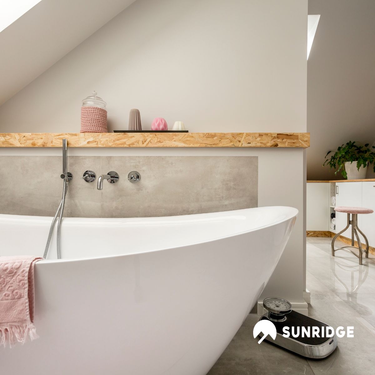 Modern bathroom with freestanding bath and wall-mounted bathroom mixer taps, styled with soft tones and minimalist design