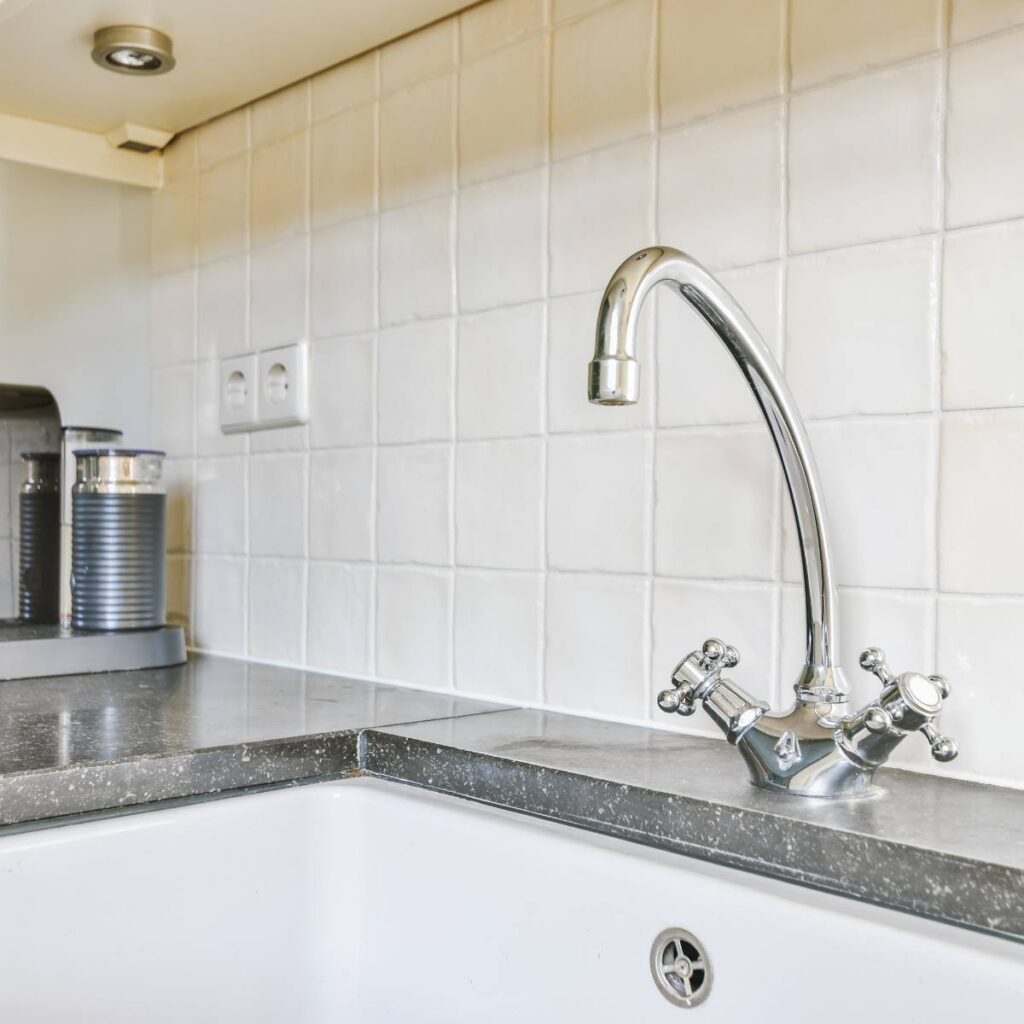 Victorian mixer taps installed in a modern kitchen, showcasing classic tap design and durable plumbing finishes