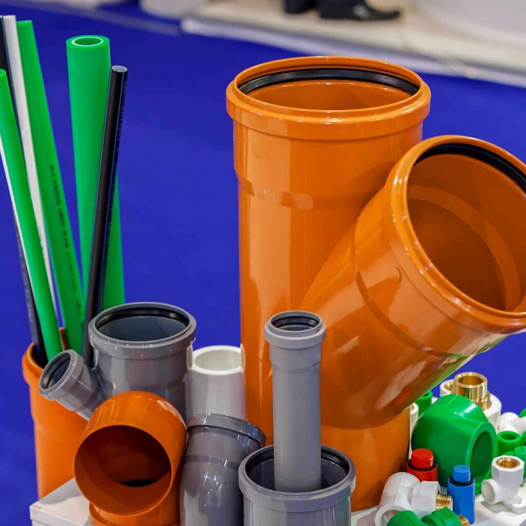 Display of quality plumbing supplies including PVC pipes, fittings, and drainage components for durable plumbing installations.