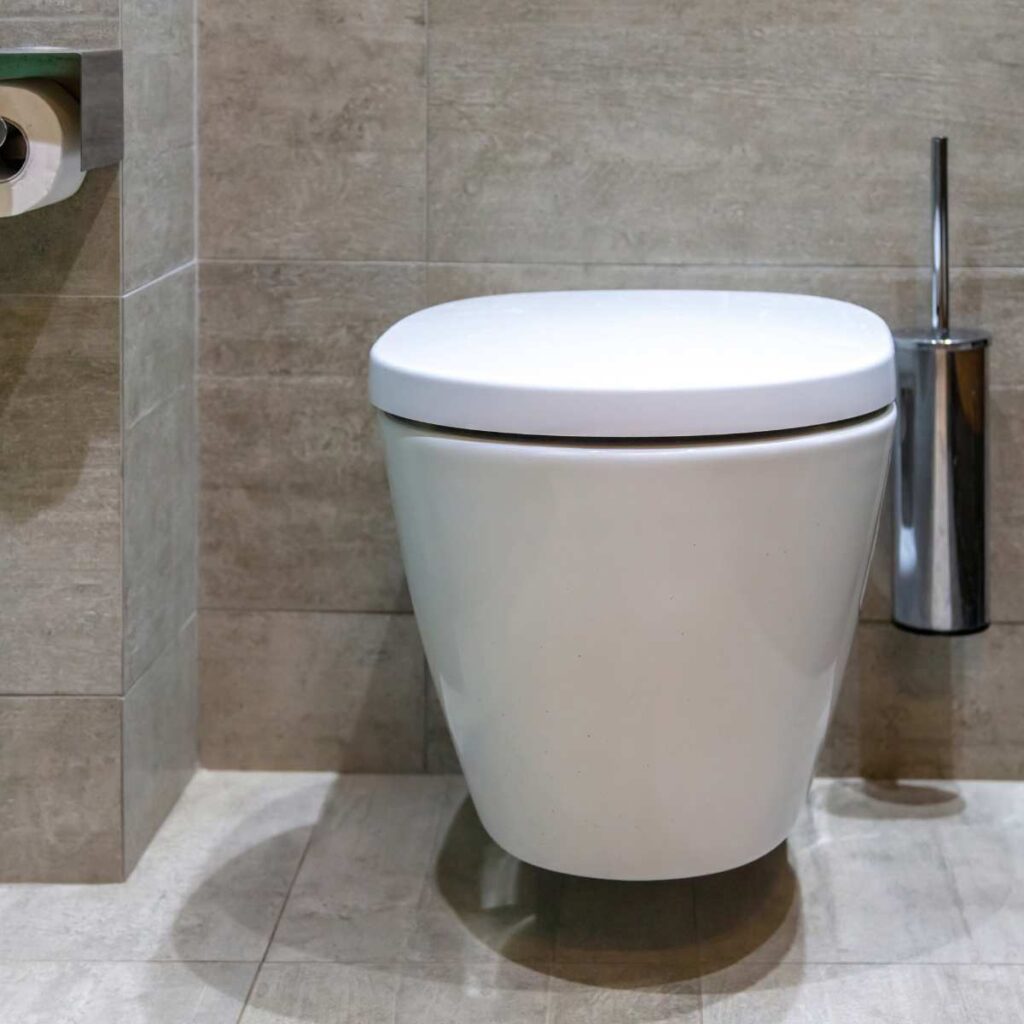 modern wall-mounted toilet cistern design in a tiled bathroom layout